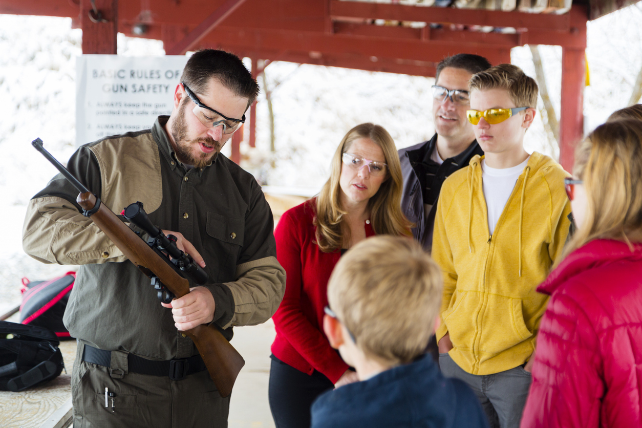 Person at a gun range practicing safe firearms handling